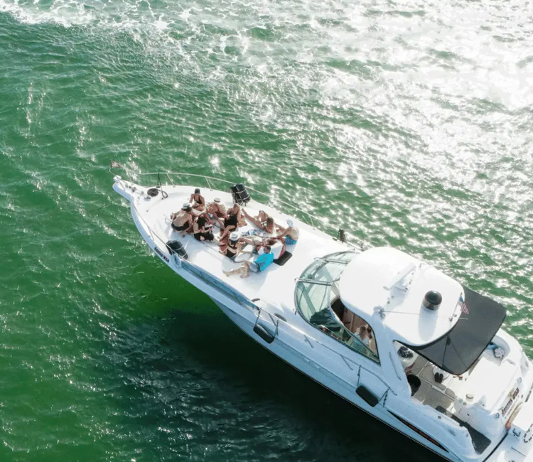 a boat with people on it in the water. featuring South Florida boating and private yacht rentals in Boca Raton