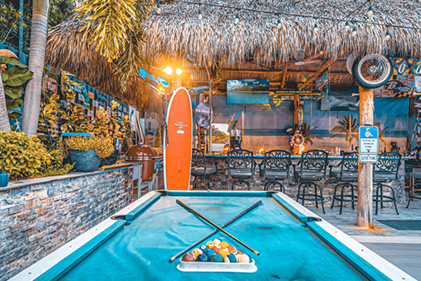 a pool with a surfboard and a pool table. featuring Fort Lauderdale and private yacht rentals by Aquaholics Florida