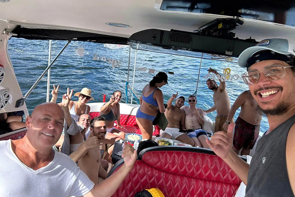 a man sitting on a boat with a bunch of people. featuring private yacht rentals and Fort Lauderdale