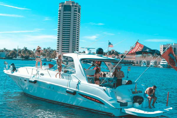 a boat is docked in the water near a city. featuring private yacht rentals and Intracoastal Waterway cruises in Pompano Beach