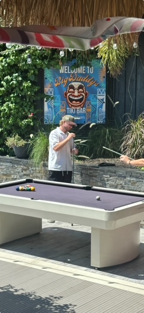 a man standing next to a pool table with a pool cue featuring luxury boat events and Fort Lauderdale by Aquaholics Florida