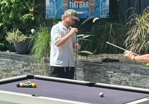 a man standing next to a pool table with a pool cue featuring luxury boat events and Fort Lauderdale by Aquaholics Florida