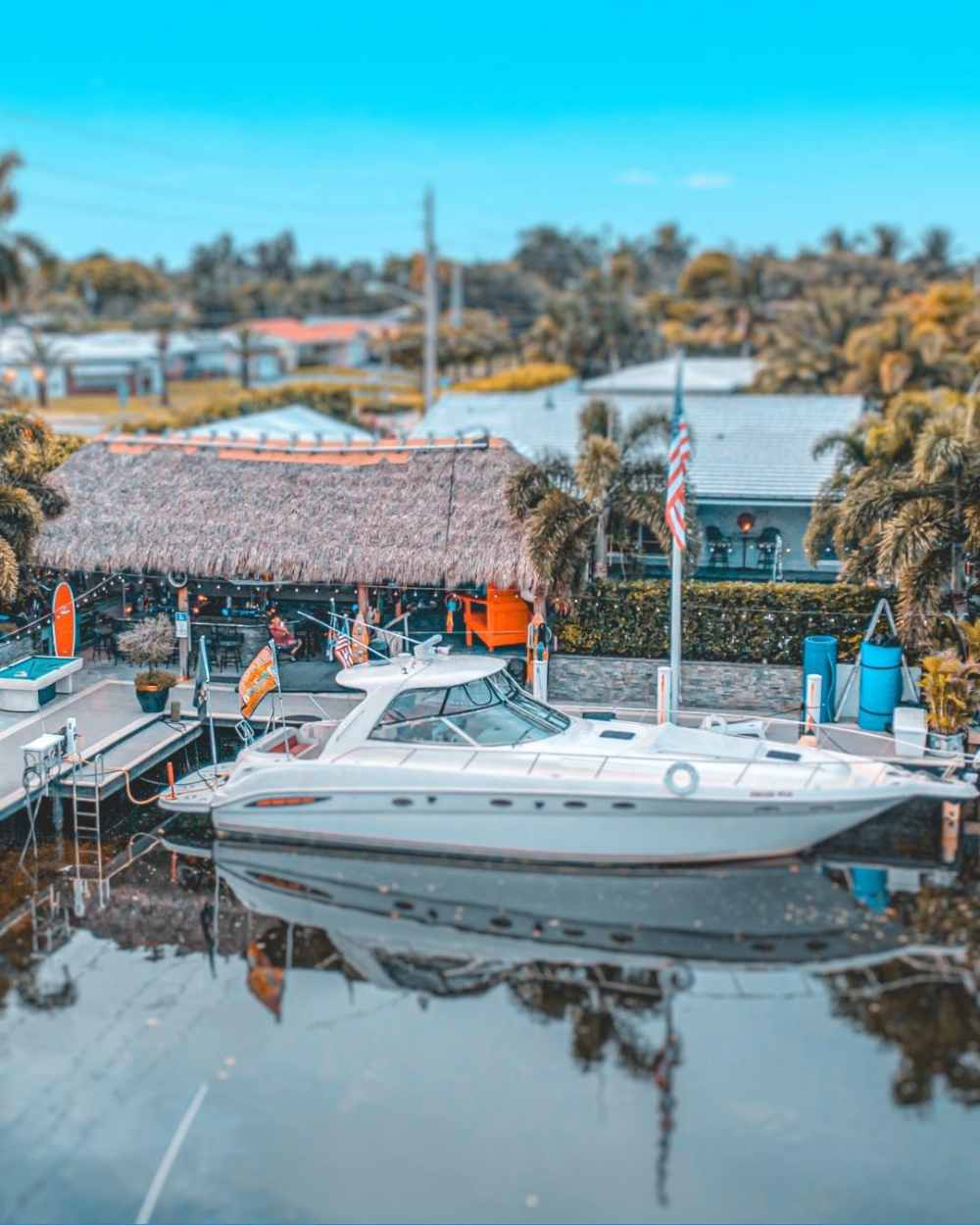 a boat is docked at a pier with a crowd of people. featuring Boca Raton and yacht charters