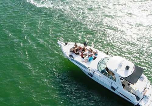 a boat with people on it in the water. featuring yacht charters and Boca Raton