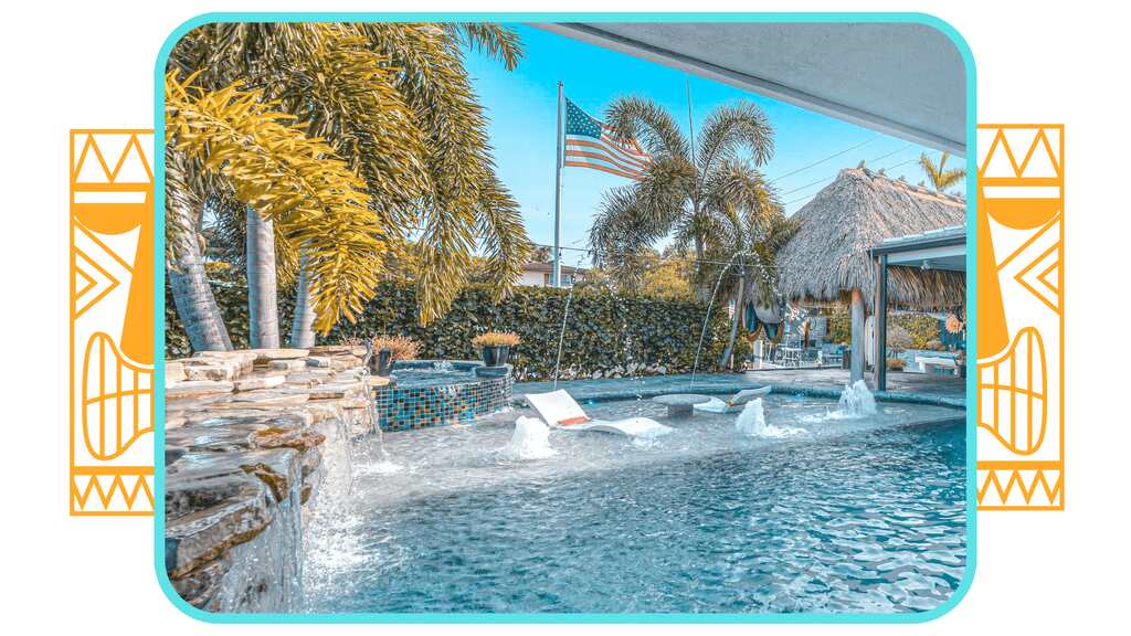 a pool with a waterfall and a beach. featuring yacht charters and South Florida boating in Pompano Beach by Aquaholics Florida