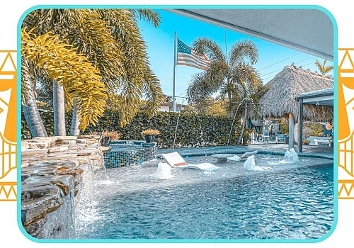 a pool with a waterfall and a beach. featuring yacht charters and South Florida boating in Pompano Beach by Aquaholics Florida